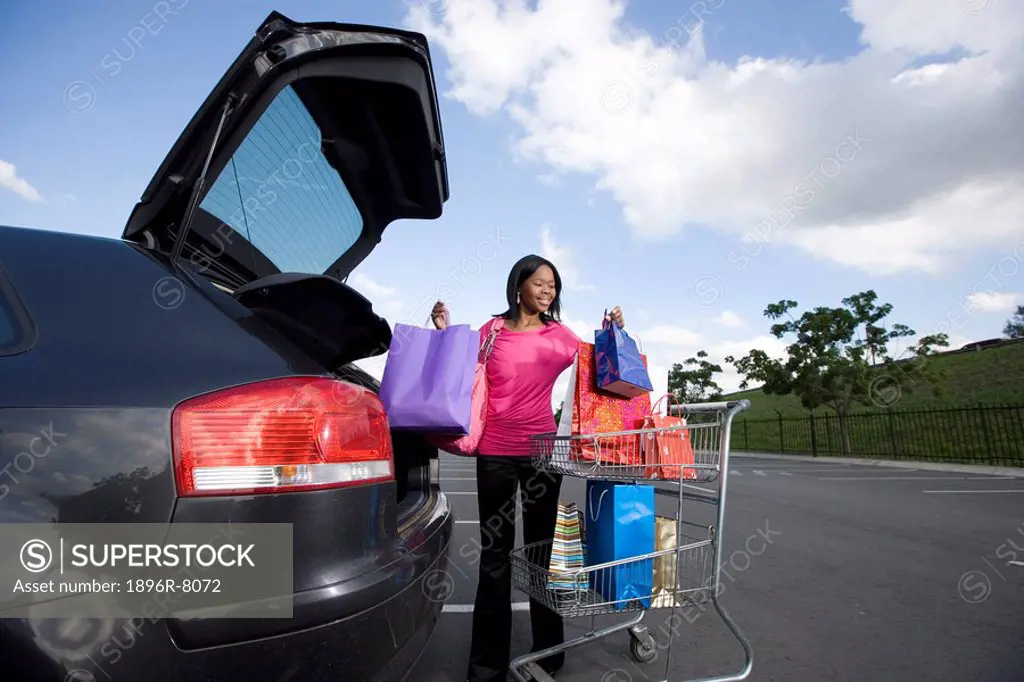 Woman loading car with shopping bags, KwaZulu Natal Province, South Africa