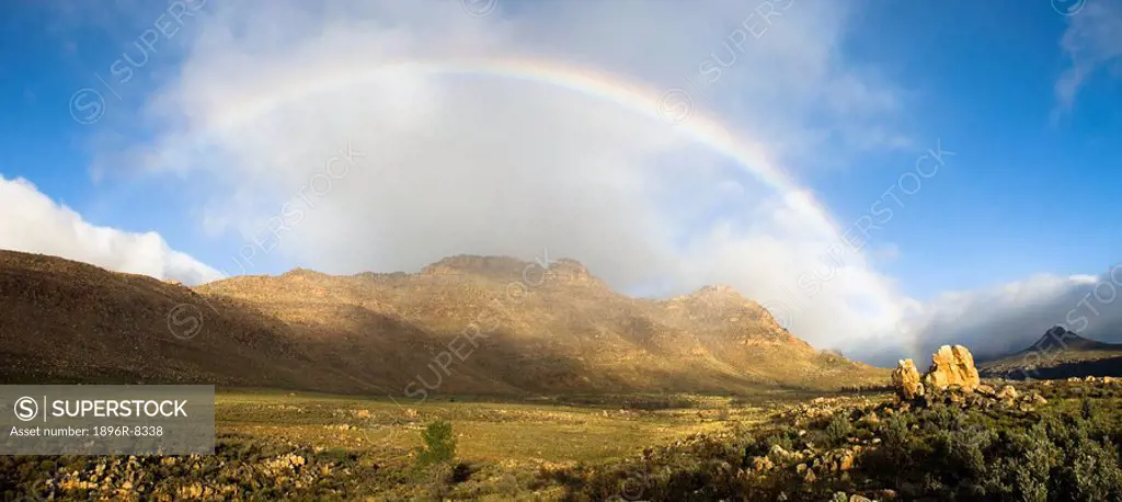 Rainbow over valley with Apollo and Luna Peaks, Cederberg, Western Cape Province, South Africa