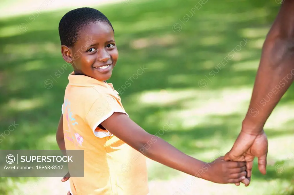 Portrait of girl 8_9 holding fathers hand, Johannesburg, Gauteng Province, South Africa