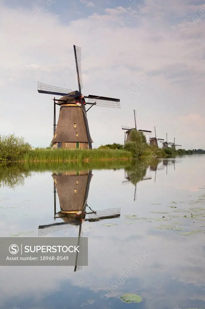 Windmills reflecting in surrounding polder waters, Kinderdijk, Nieuw_Lekkerland, Netherlands