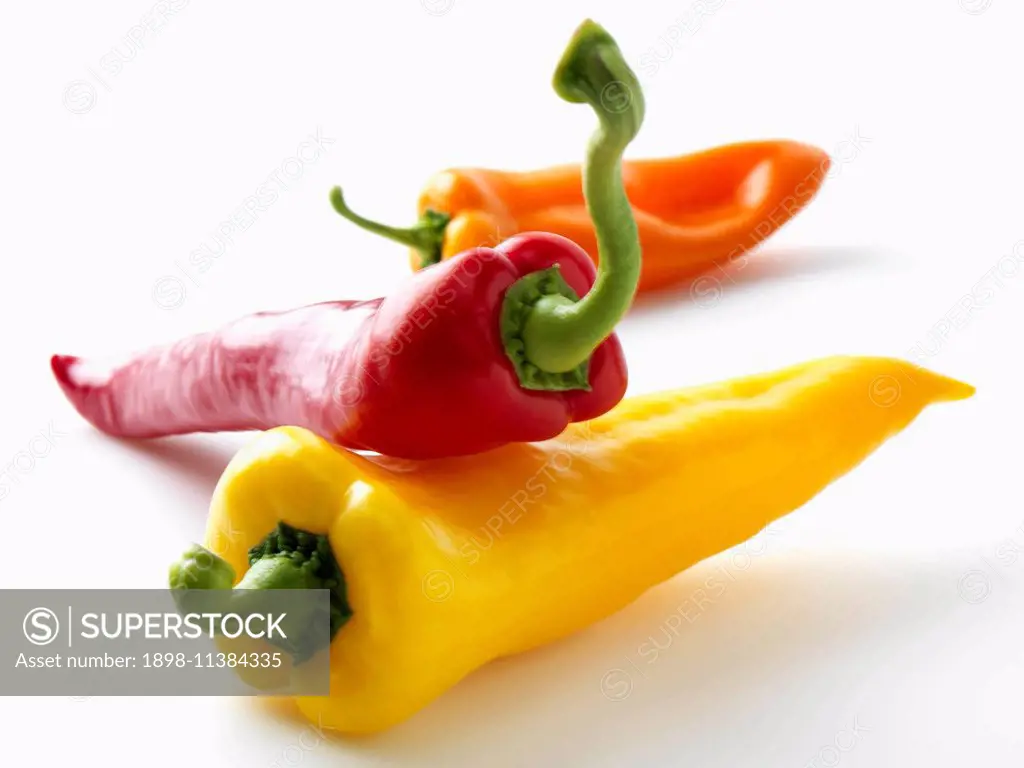 Red yellow orange sweet peppers on a white background