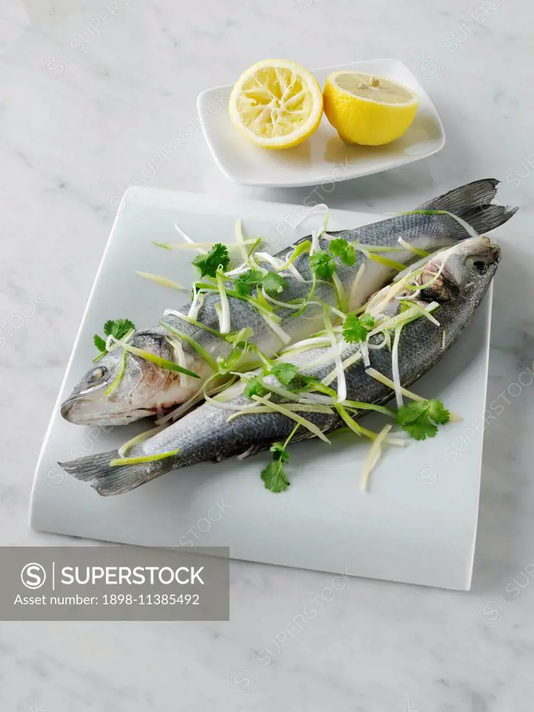 Sea bass cooked in foil with ginger and spring onions