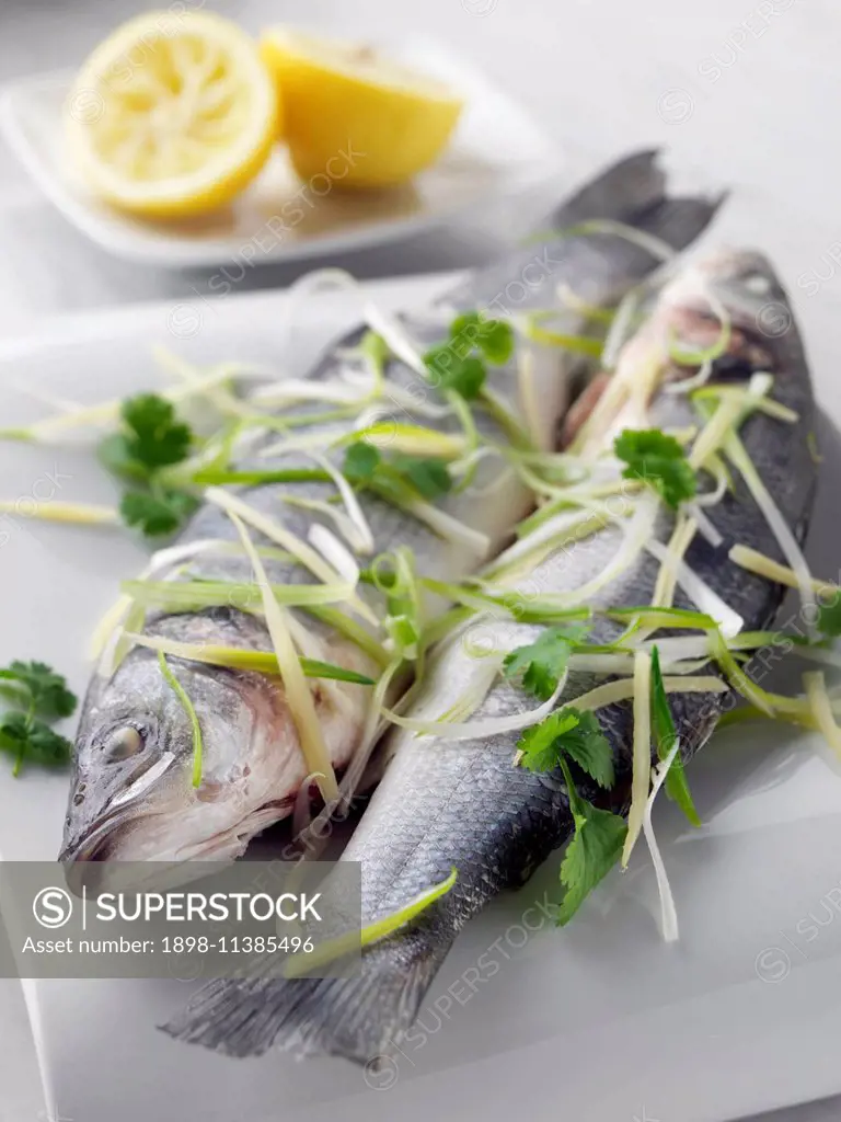 Sea bass cooked in foil with ginger and spring onions