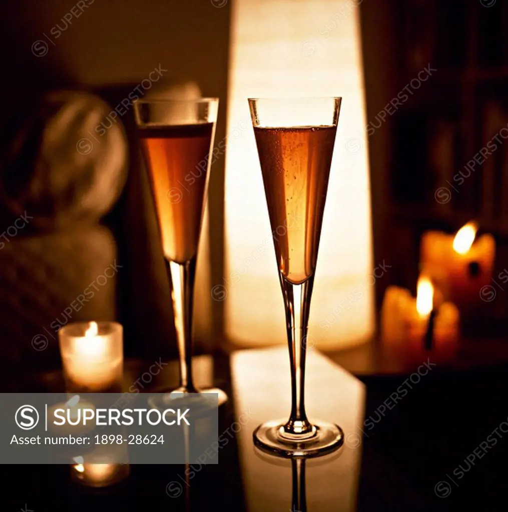 Glasses of champagne and lit candles.
