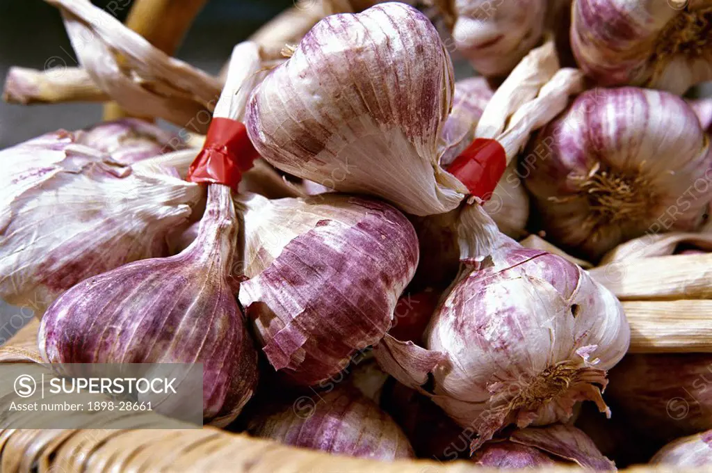 Close up of garlic bulbs in a basket.