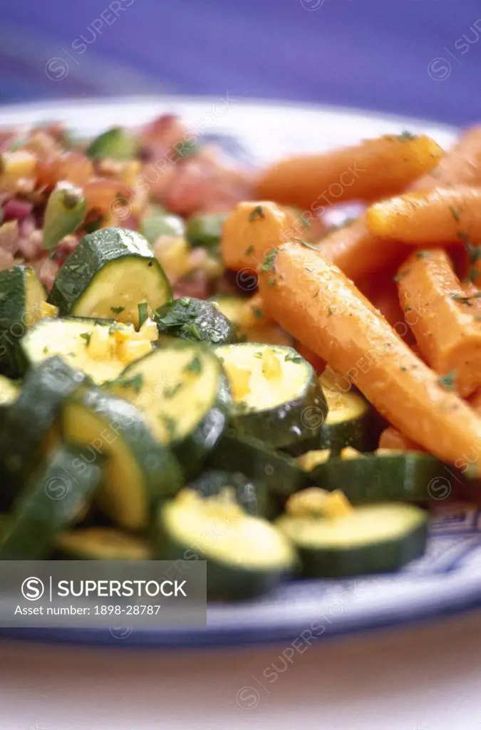Plate of zucchini and carrot salad garnished with parsley.
