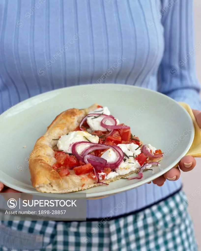 Woman holding slice of pizza on plate