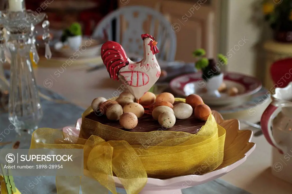 An Easter cake with chocolate eggs and ornamental cockerel