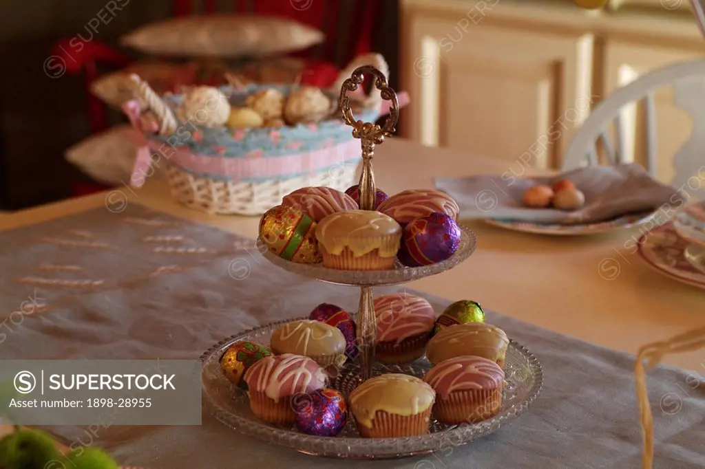 Decorative cake stand on table with cakes