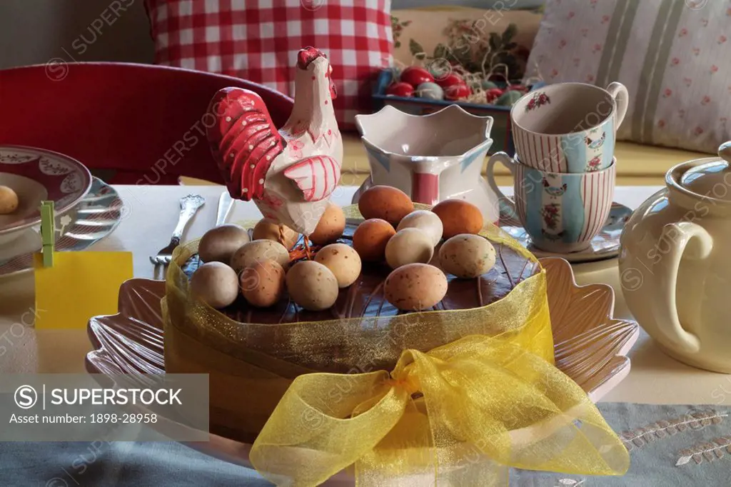 Easter cake on table with cups and saucers