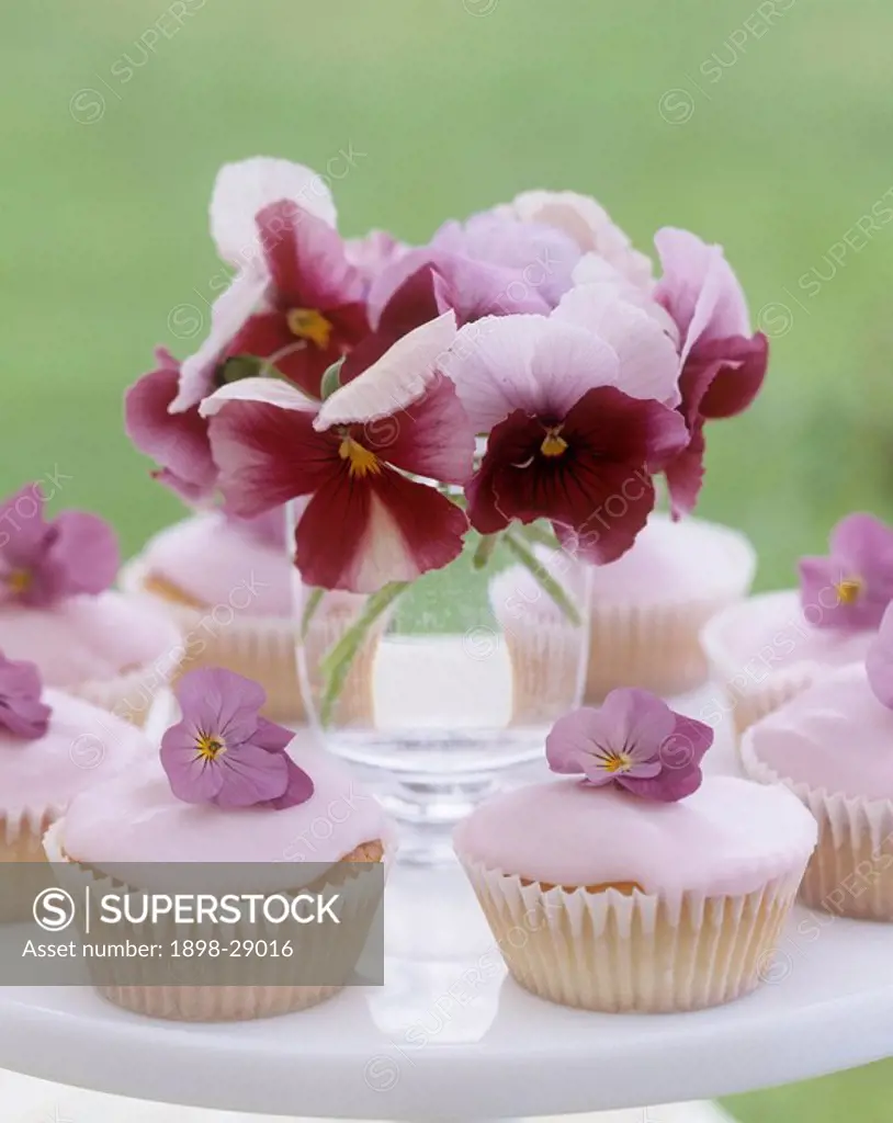 Fairy cakes and posy of pansy flowers
