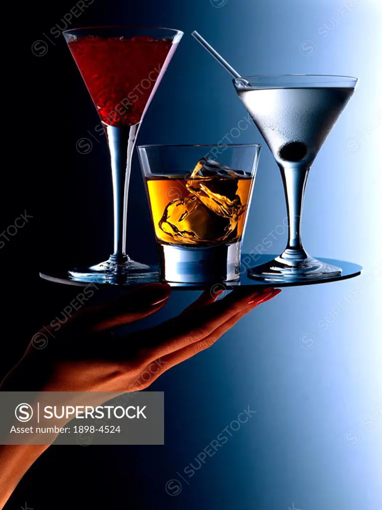 Cocktails on a tray with hand