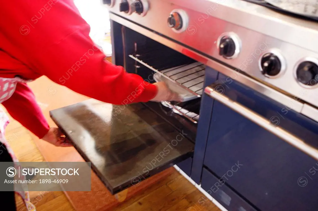 Woman placing Dish in Oven