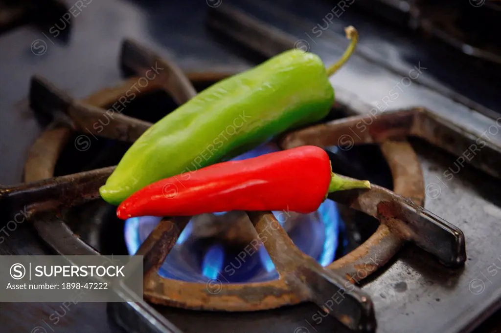 Green and Red Chili Peppers over Flame
