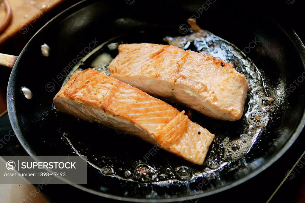 Salmon frying in a Pan