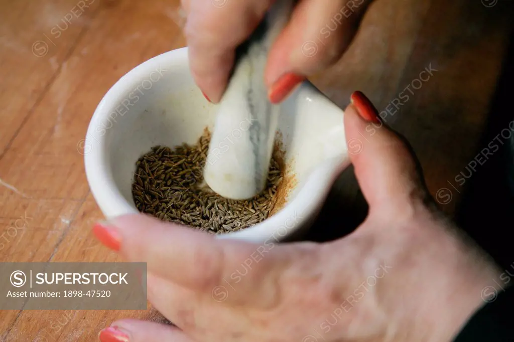 Cumin Seeds with Pestle and Mortar