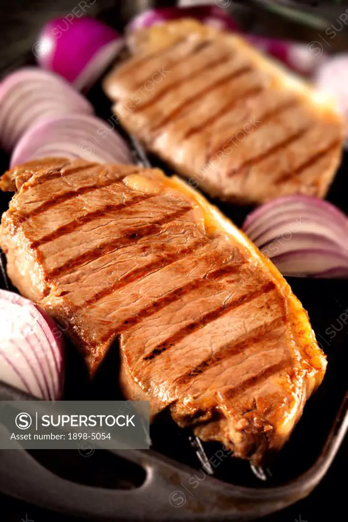 Sirloin steaks with red onions