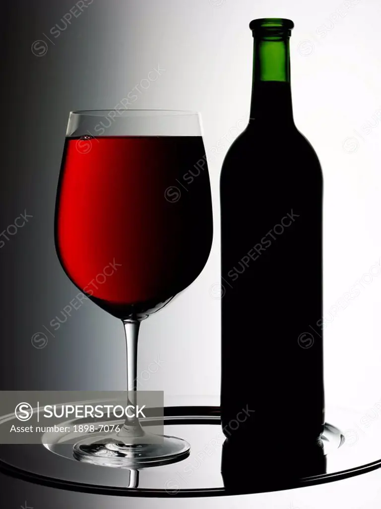 GLASS OF RED WINE WITH BOTTLE
