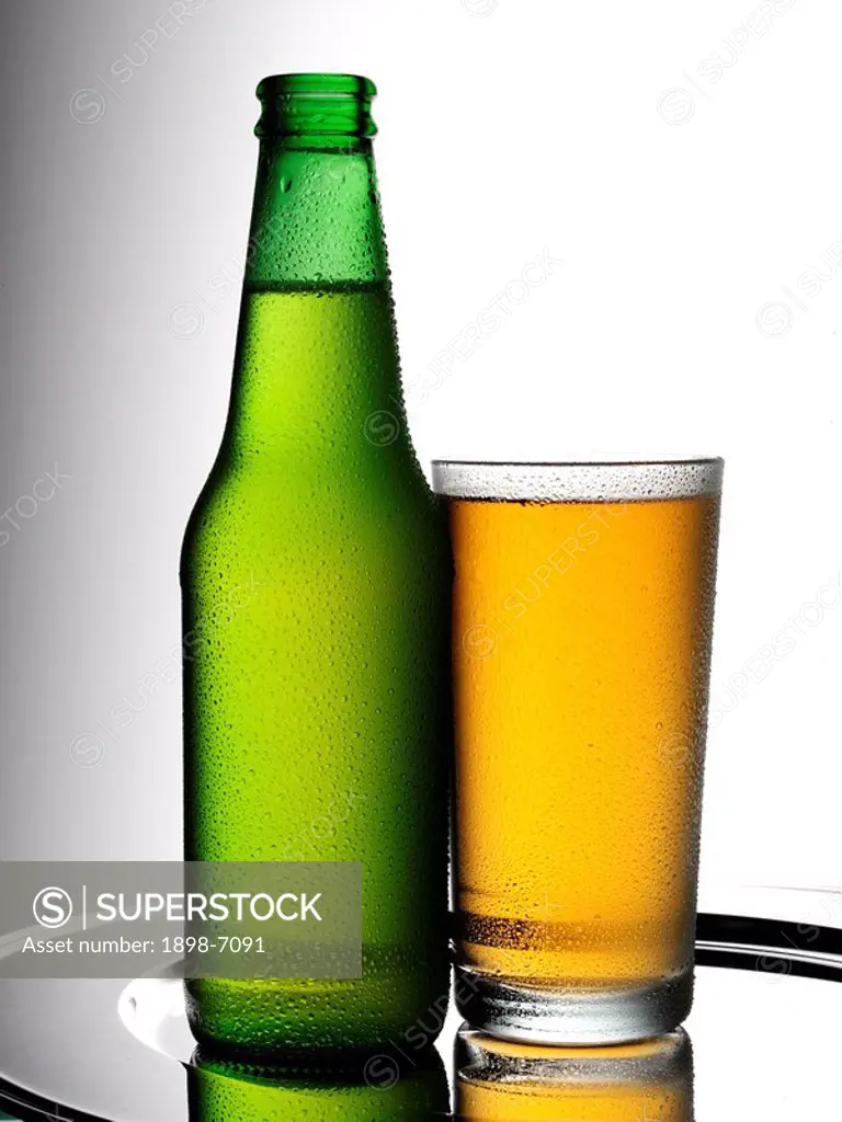 BOTTLE OF BEER AND GLASS