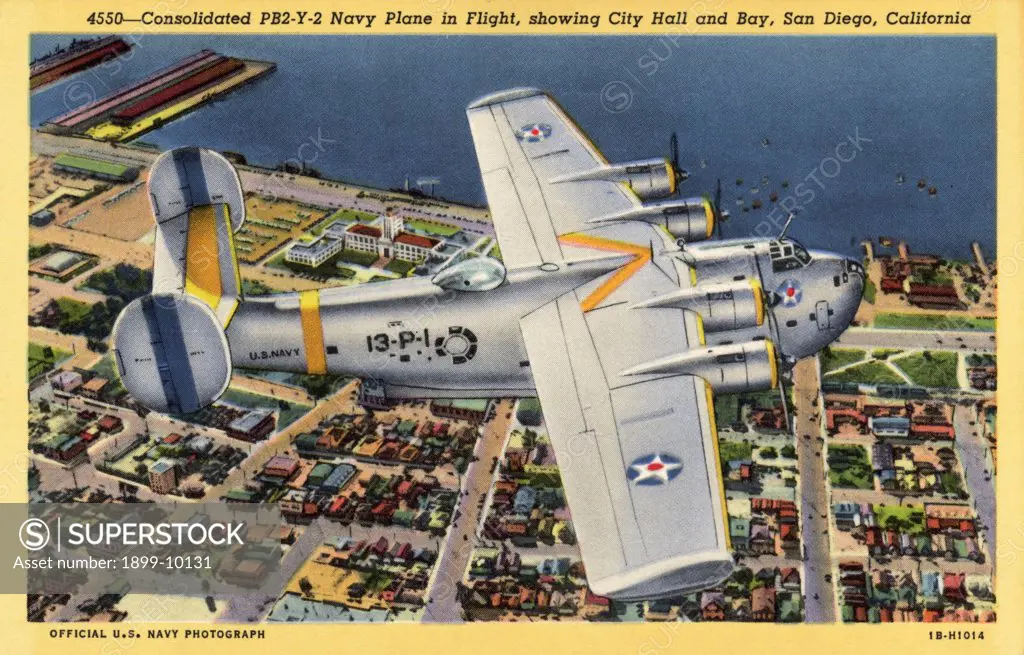 Navy Plane in Flight. ca. 1941, San Diego, California, USA, 4550--Consolidated PB2-Y-2 Navy Plane in Flight, showing City Hall and Bay, San Diego, California 