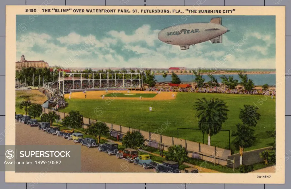 Blimp over Waterfront Park. ca. 1933, St. Petersburg, Florida, USA, THE 'BLIMP' OVER WATERFRONT PARK, ST. PETERSBURG, FLA., 'THE SUNSHINE CITY'. THE BASEBALL FIELD. One of St. Petersburg's many sport attractions, located in Waterfront Park on Tampa Bay. 