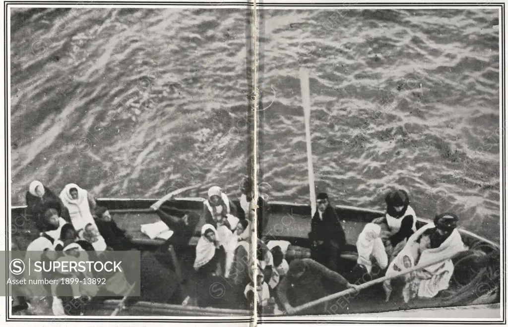 Titanic Survivors. How the Titanic Survivors Were Picked up by the Carpathia. Photograph taken by Mr J W Barker of a boatload of Titanic survivors, showing babies, women and seamen with oars. Carpathia was sailing from New York City to Rijeka on the night of Sunday, 14 April 1912. The captain, Arthur Henry Rostron, was asleep in his cabin when wireless operator Harold Cottam burst in and told him of Titanic's distress signal. Captain Rostron immediately set course to the liner's last known posit