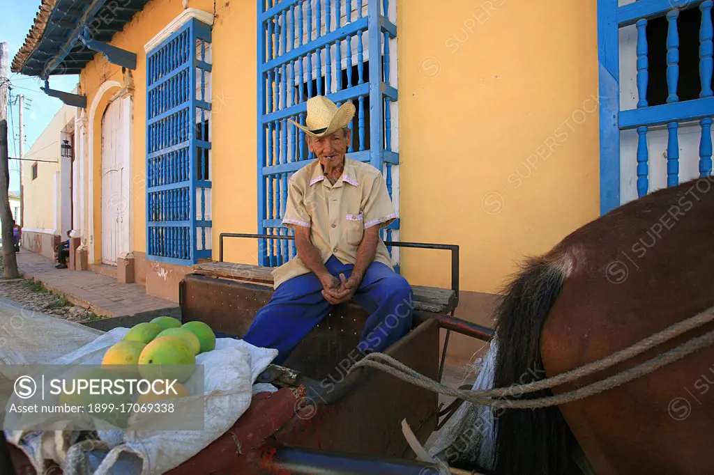 Cuban man with papaya. Trinidad. Cuba island. West Indies. Central America