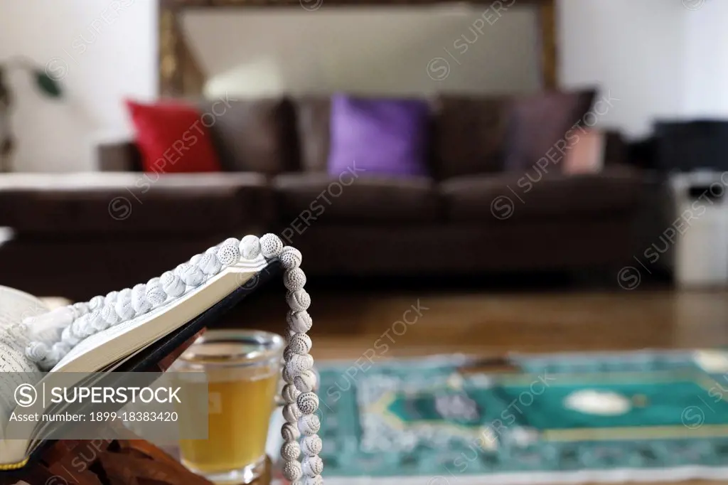 Open Quran on Muslim prayer mat at home. France. (Photo by: Pascal Deloche/Godong/UIG)