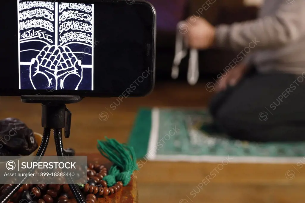 Muslim man pray at home during Ramadan. France. 