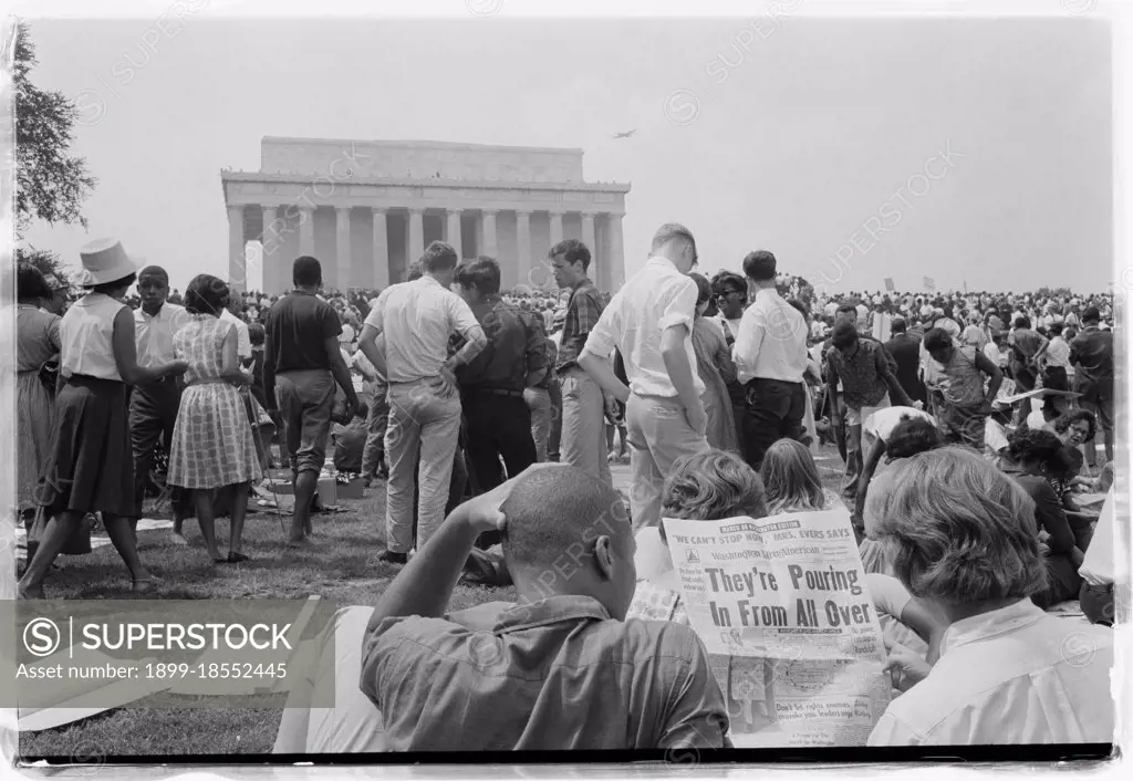 Two people at the March on Washington for Jobs and Freedom read the headlines about the crowds attending the event. (GG Vintage Images/UIG)