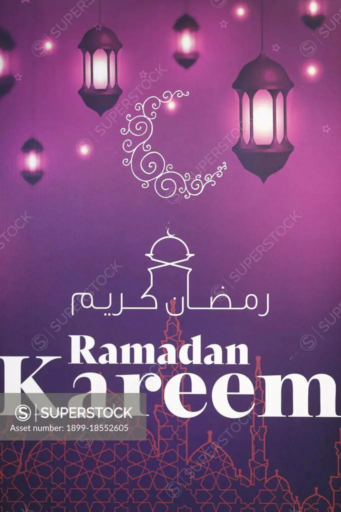 Ramadan kareem arabic calligraphy greeting with crescent and lanterns. Dubai. United Arab Emirates.