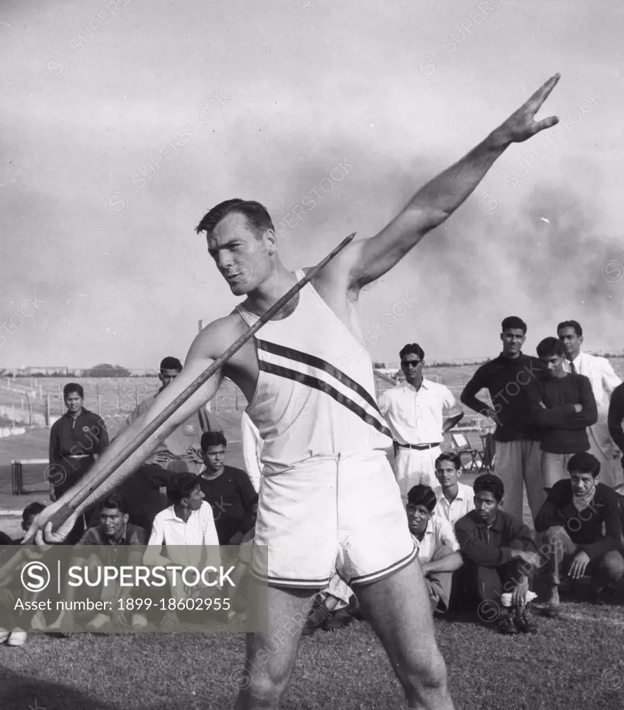 Bob Mathias (1930-2006), US Olympic decathlete, demonstrates the javelin throw for the benefit of young athletes at the Vallabhbhai Patel Stadium during his good will tour of more than 40 countries sponsored by the US State Department, Bombay, India, 1956. (Photo by United States Information Agency/GG Vintage Images)