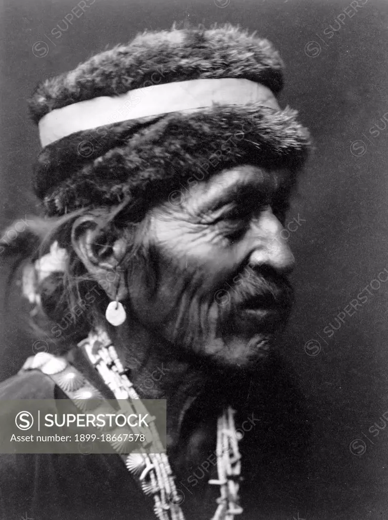 Edward S. Curits Native American Indians - Navajo Indian Man wearing fur cap circa 1905.