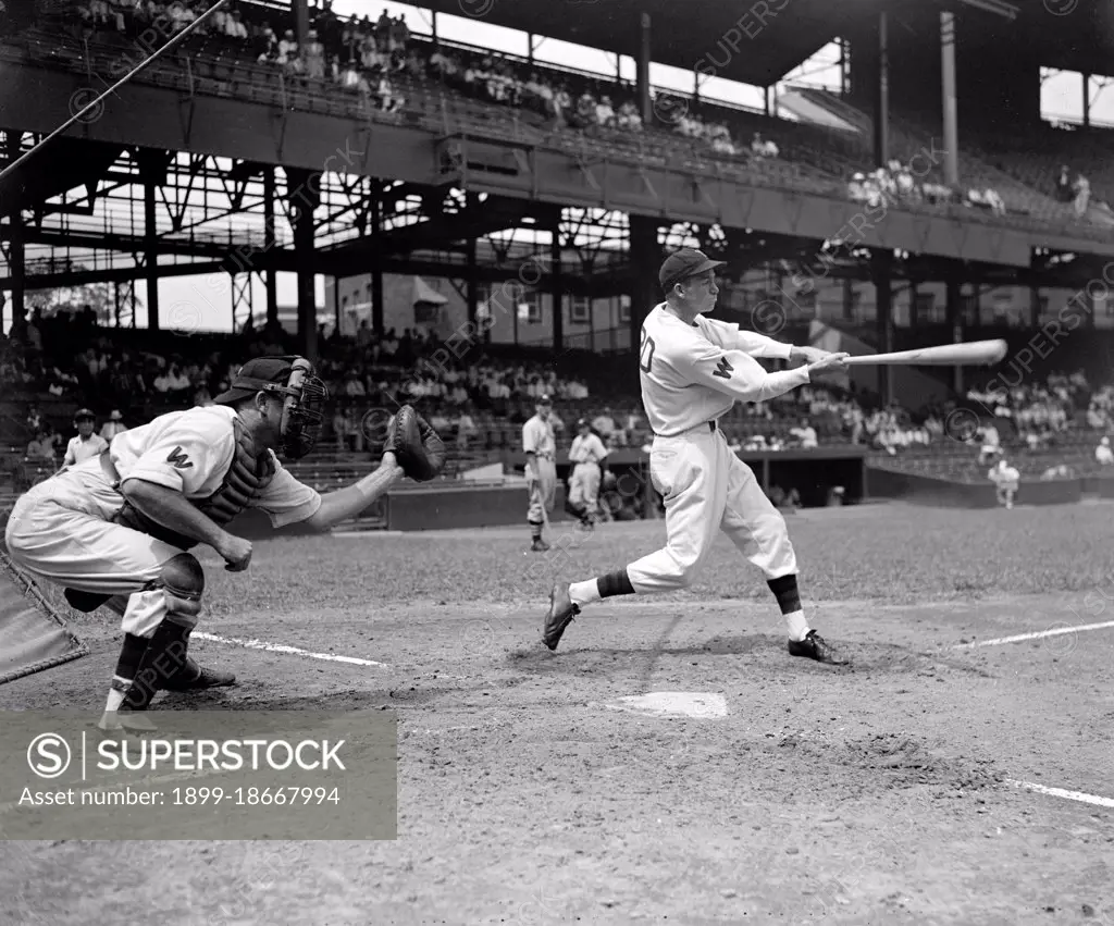 Buck Jacobs, Washington baseball player swinging at a baseball while at bat circa 1937.