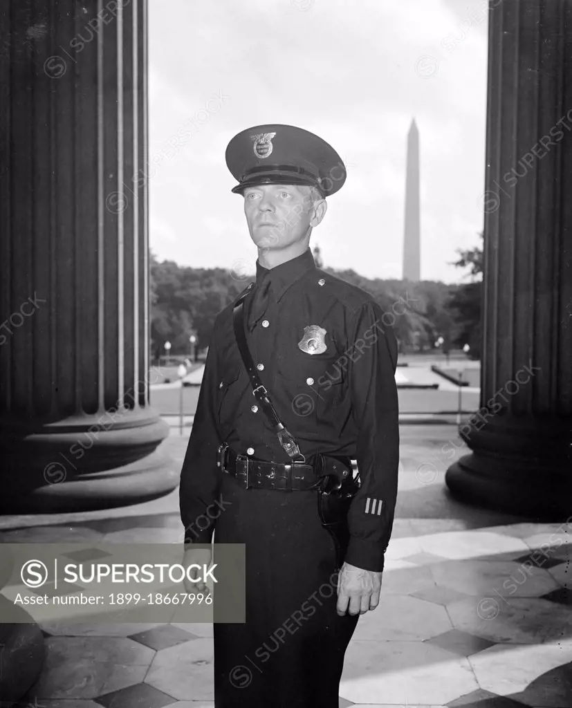  A U.S. Treasury Guard is displaying a new uniform for Treasury Officers circa 1937.
