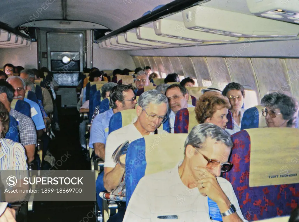 (R) Latin America / Honduras circa 1987 - Passengers onboard an airplane in late 1980s.