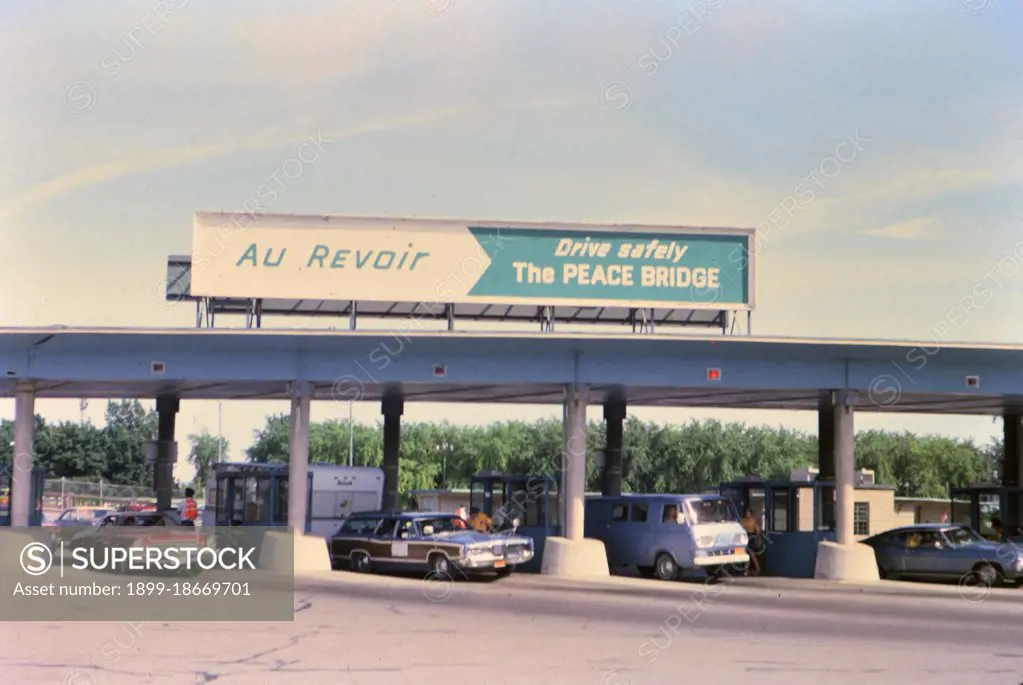 (R) New York 1975 - U.S. Canada border crossing - cars leaving the country circa 1975.