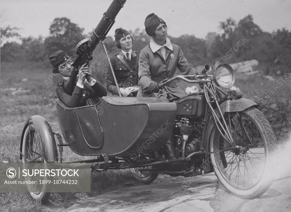 Women's machine gun squad police reserves, (l-r), Captain Elise Reniger, manning the gun, Miss Helen Striffler on the rear seat, and Mrs Ivan Farasoff driving, practice with a Lewis machine gun, which is to be sent to France with the troops, Washington, DC, 08/01/1918.