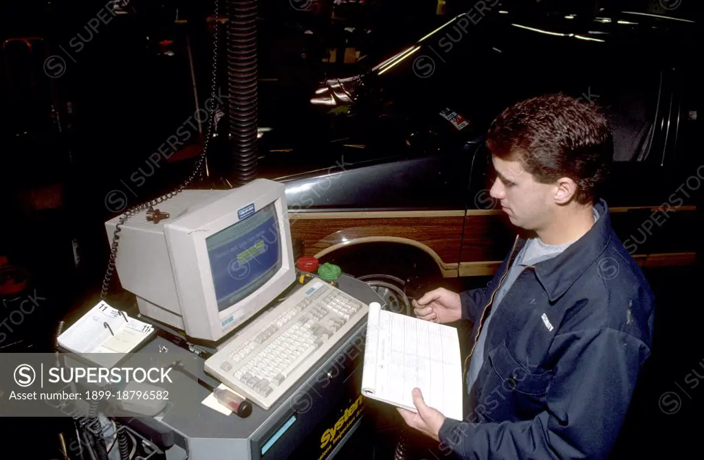 Technician performing an emissions test on a vehicle November 11, 1992. 