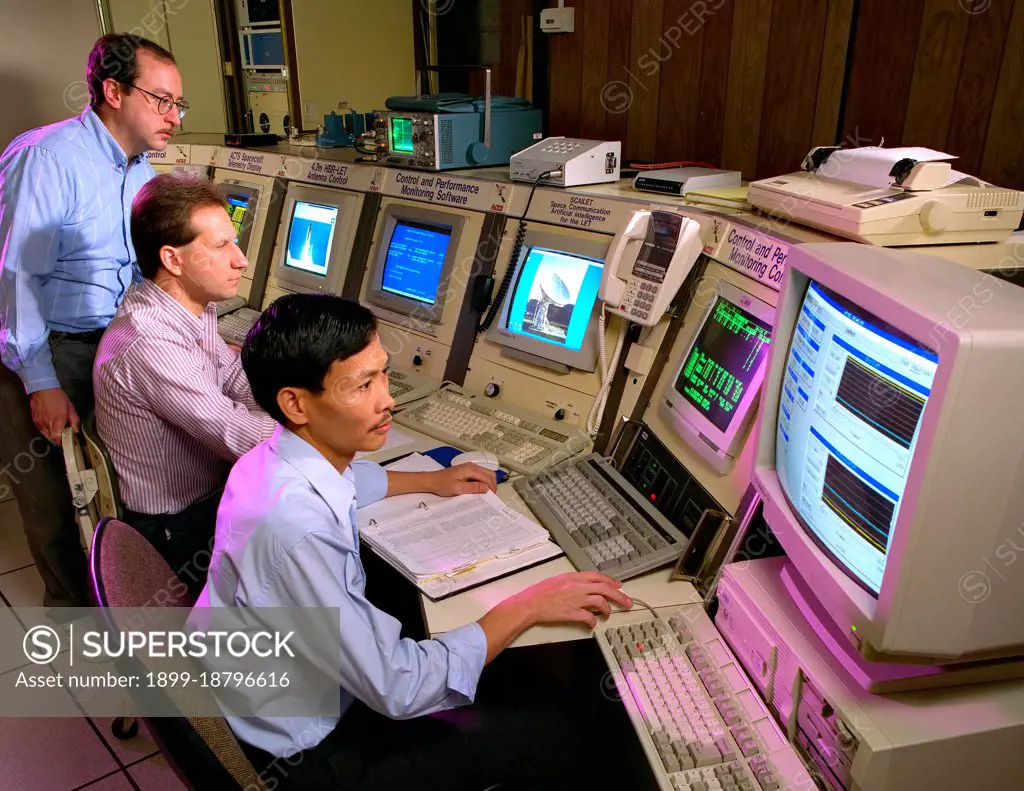 Workers at NASA's Lewis Research Center - viewing information on computer monitors in 1996. 