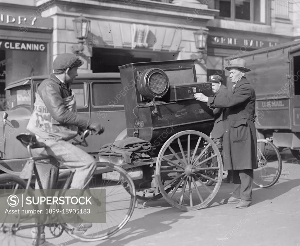 Street scene: bike, man with cart near laundry ca. between 1909 and 1932.