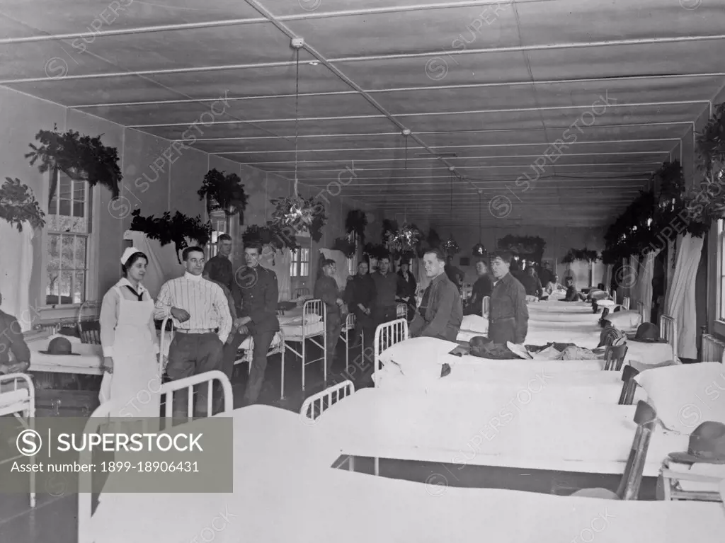 Soldiers and nurse in military hospital, during Christmas season ca.  1910.