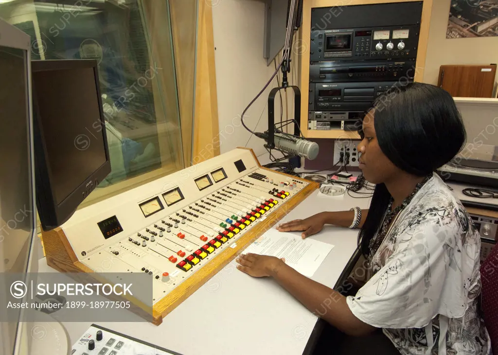 An African-American senior from Calvert High School in Calvert Texas has an opportunity to view the radio studio in the United States Department of Agriculture Creative Media and Broadcast Center from the control booth while on a Career Opportunity tour of USDA as part of a senior trip sponsored by the Farm Service Agency Ag in the Classroom” program. 