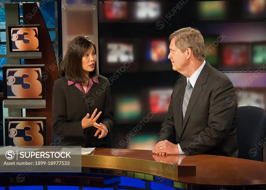 Michelle Wang (left) a news anchor with the CBS affiliate KMTV Channel 3 in Omaha, Nebraska interviews Agriculture Secretary Tom Vilsack (right) during a live broadcast after Secretary Vilsack held a town hall meeting at the Glenwood Community High School in Glenwood, Iowa Thur., June 16, 2011. Farmers, local and regional media listened and questioned Secretary Vilsack on the cause of the floodwaters along the Missouri River affecting Iowa and Nebraska. Secretary Vilsack offered advice and assistance available through the United States Department of Agriculture and other federal agencies. 