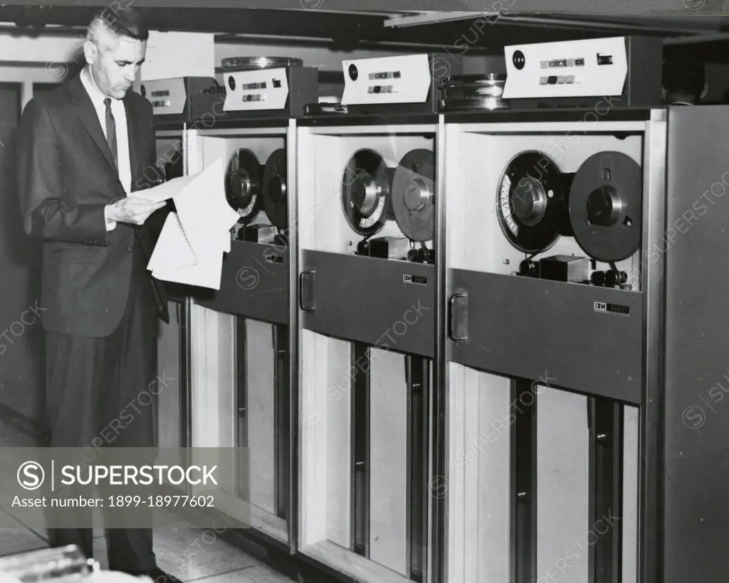 Edward Stone in front of an IBM Computer Tape Bank July 1967. 