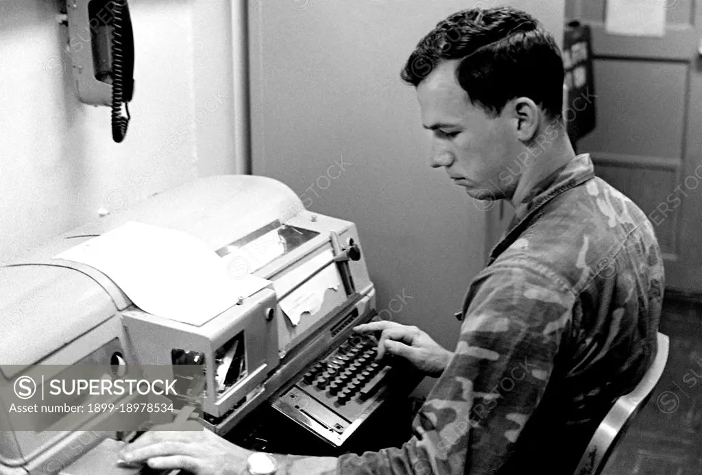 1979 - A Marine teletype operator puts in long hours sending and receiving messages for the 32nd Marine Amphibious Unit. 