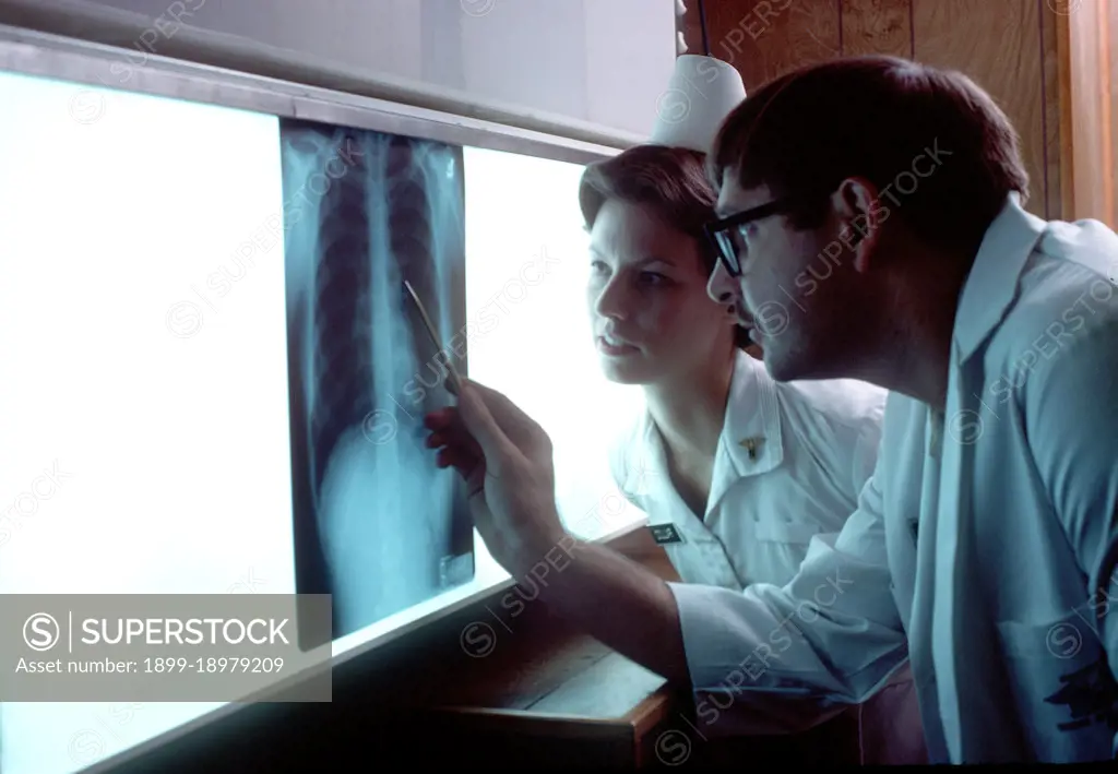 1977 - A doctor and nurse examine an X-ray. 