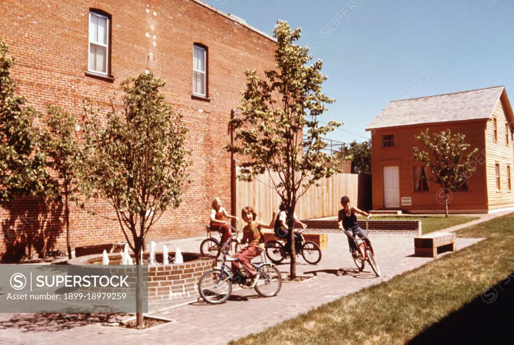 Kids ride their bicycles in a small new park in New Ulm, Minnesota. 