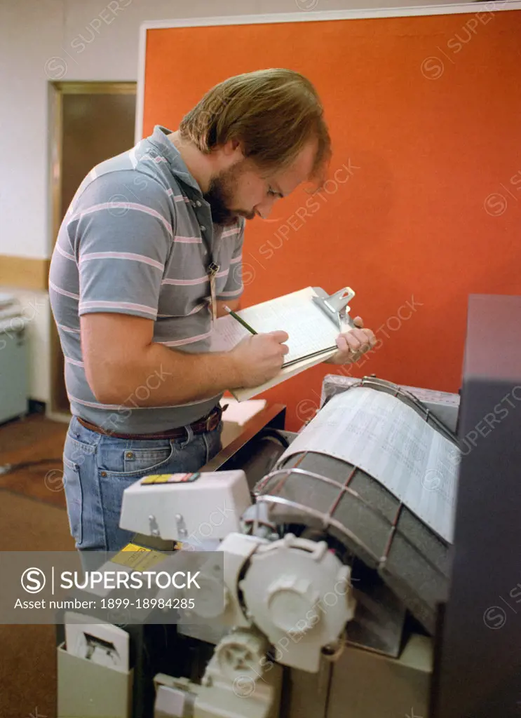 A technician monitors a computer printout while testing the electrical circuits of an MGM-118 Peacekeeper (formerly MX) intercontinental ballistic missile control guidance system.. 