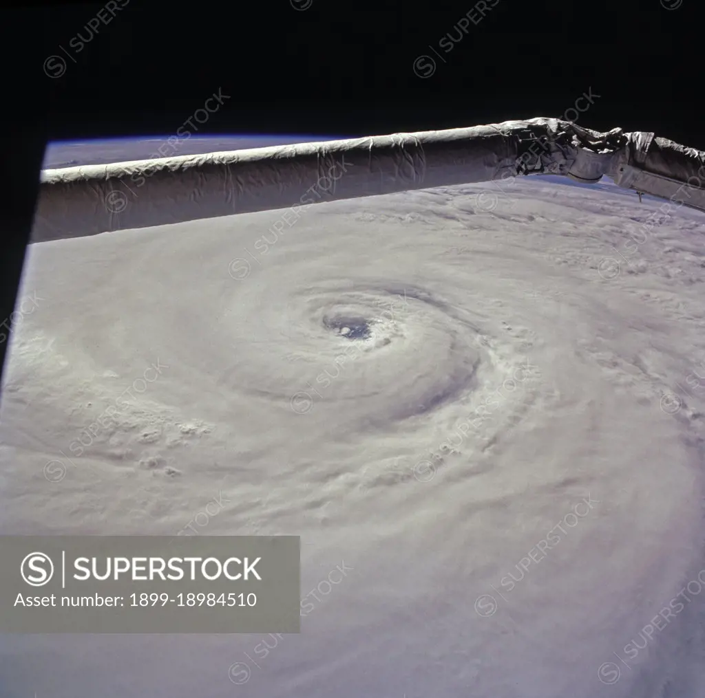 (15 August 1997) --- This view of supertyphoon Winnie was taken on August 15, 1997, as the storm swirled about 400 miles south of the southern tip of Japan.  Sustained winds were 105 knots, gusting to 130 knots.  This photo was shot on the Space Shuttle Discovery's twenty-third flight, as it glided by 170 miles above the sea surface on Orbit 123.  On one pass the Discovery flew right over the eye; the commander commented that the eye was so large that it completely filled the window.  The robotic arm crosses the top of the view.  The cloud mass associated with Winnie covered thousands of square miles as this storm grew to supertyphoon status in the previous days, and raked across the Marianas Islands.  A few days after this shot was taken, Winnie ploughed ashore on the coast of China, a bit south of the major metropolis of Shanghai, reportedly killing at least 100 people.. 